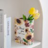 Sunflower book vase styled beside books