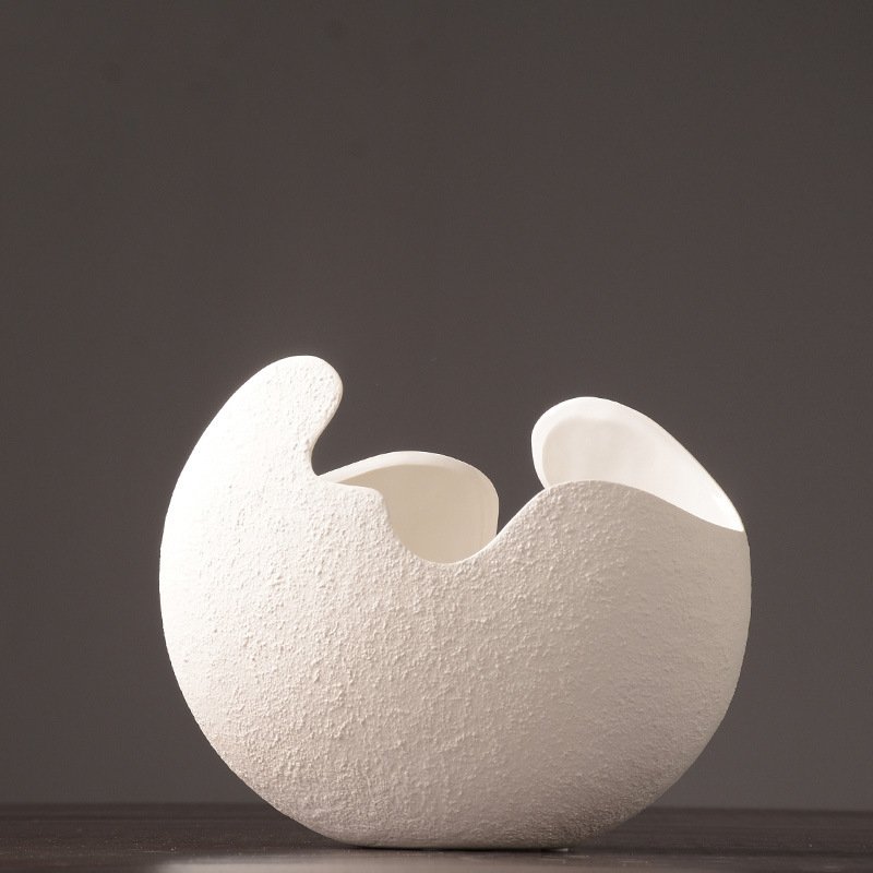 Organic white ceramic vase with a sculptural open rim