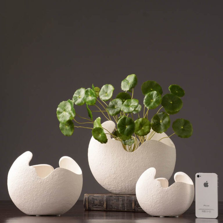 Organic white ceramic vases shown in three sizes Organic white ceramic vases shown in three sizes