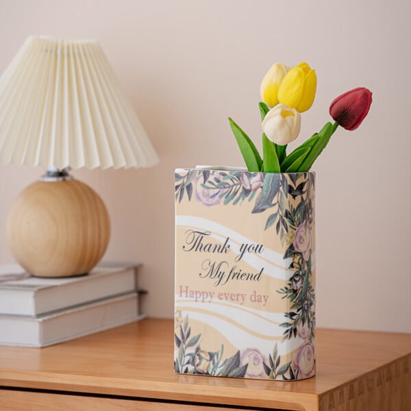 Floral book-shaped vase with stems