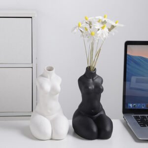 Black and white sculptural ceramic body vases displayed together
